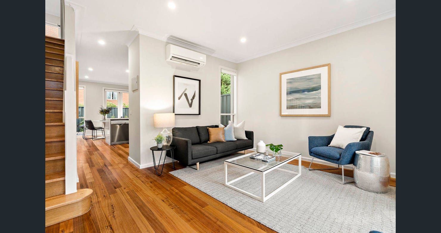 Open living area with timber floors and staircase