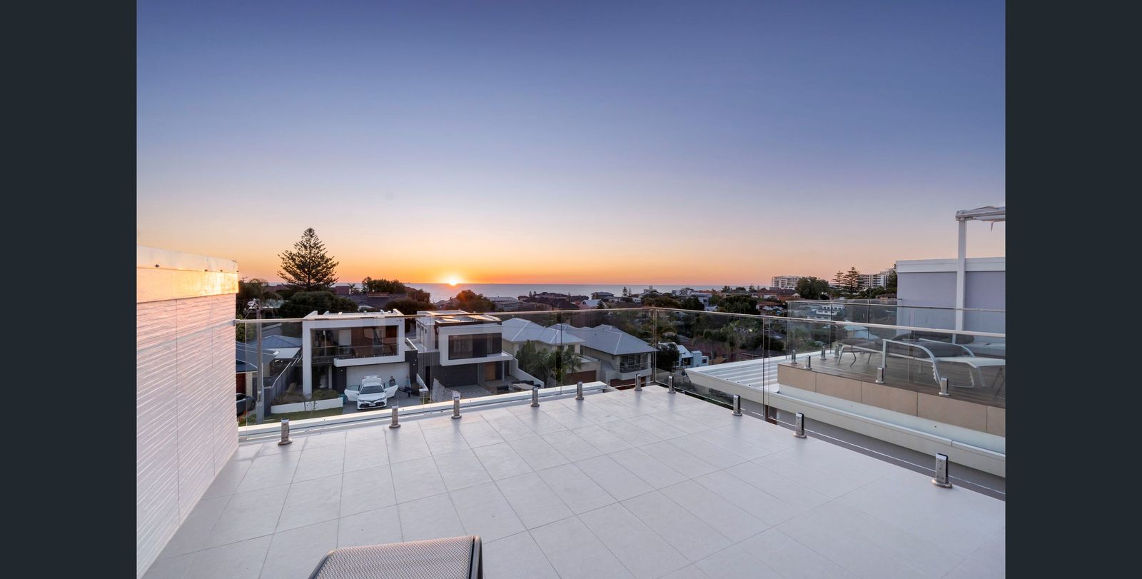 Rooftop terrace at sunset overlooking the coastline